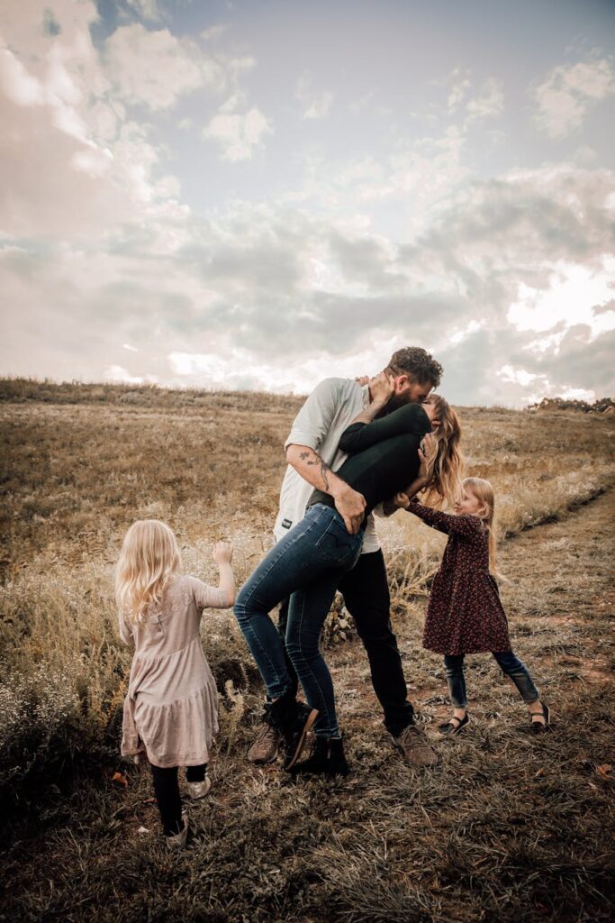 couple standing with two girls behind